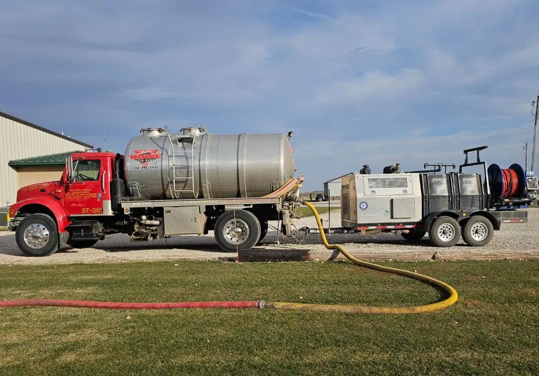 Septic tank service technician performing routine maintenance and evaluation of residential system