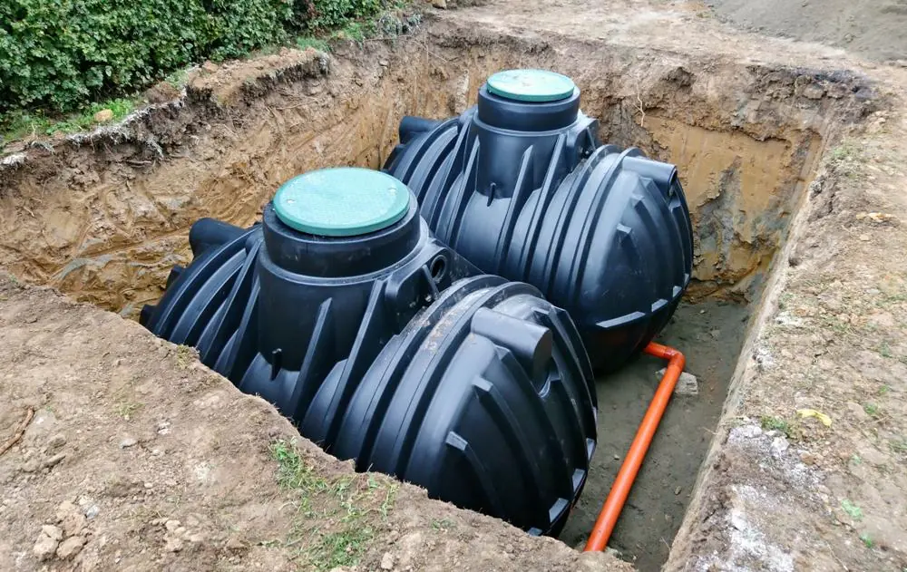 Two septic tanks positioned below ground with connecting pipework