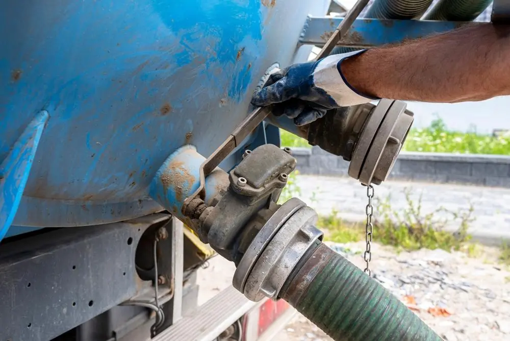 Worker operating a valve on a pumping truck