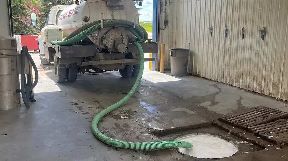 Salhus service truck pumping through a hose inside a shop